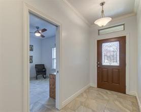 foyer entrance featuring baseboards and crown molding