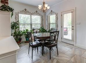 dining room with baseboards, crown molding, a chandelier, and a wealth of natural light