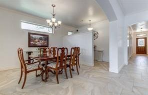 dining space featuring arched walkways, an inviting chandelier, and baseboards