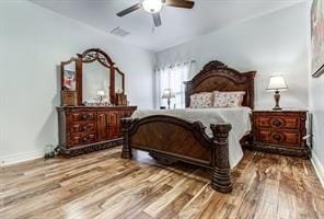 bedroom with ceiling fan, baseboards, and wood finished floors