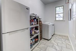 laundry room with laundry area, washer and dryer, and baseboards