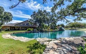 view of pool featuring a water view and a lawn