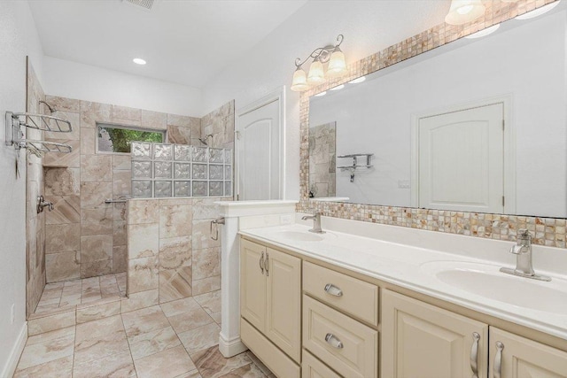 604 Caprock Canyon Trl, Georgetown, TX 78633 - full bathroom featuring double vanity, visible vents, a walk in shower, and a sink