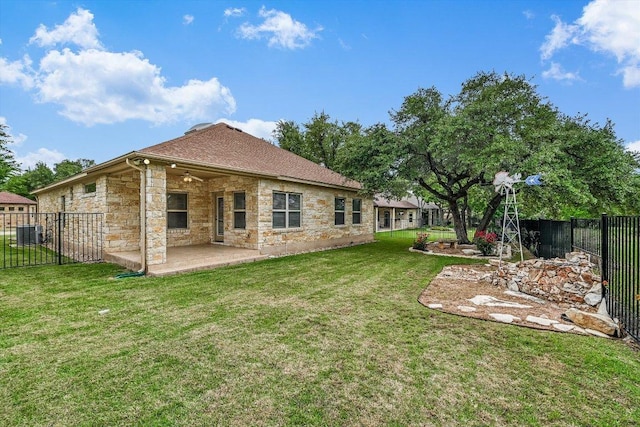 604 Caprock Canyon Trl, Georgetown, TX 78633 - back of house featuring a lawn, central AC, a patio area, stone siding, and a fenced backyard