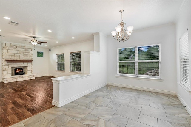 604 Caprock Canyon Trl, Georgetown, TX 78633 - unfurnished dining area featuring ceiling fan with notable chandelier, visible vents, a stone fireplace, ornamental molding, and recessed lighting