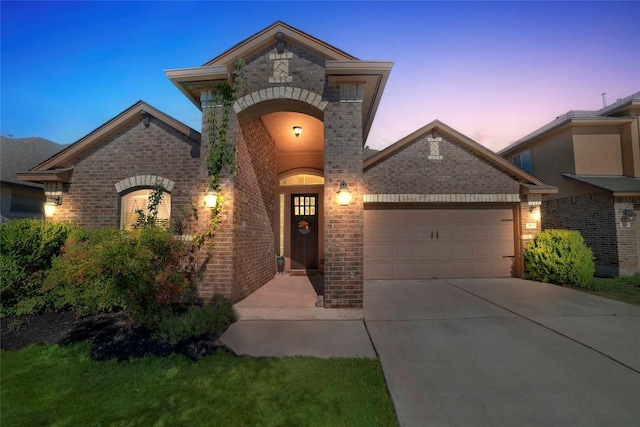 2405 Billy Pat Rd, Leander, TX 78641 - french provincial home featuring brick siding, an attached garage, and driveway