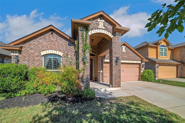 view of front of house featuring driveway and brick siding