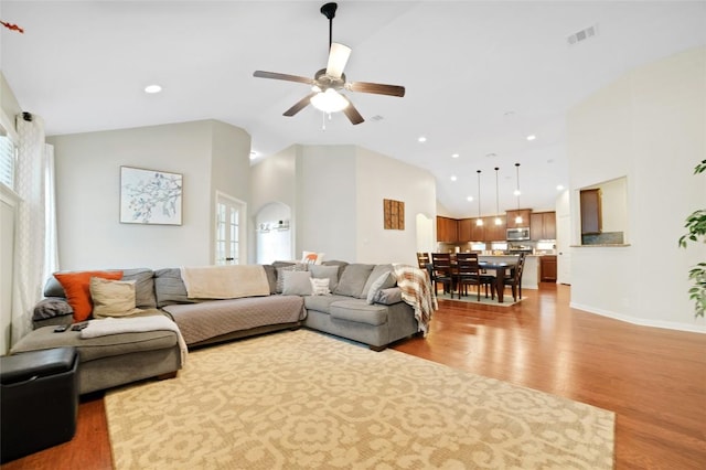 2405 Billy Pat Rd, Leander, TX 78641 - living area featuring lofted ceiling, light wood finished floors, ceiling fan, plenty of natural light, and recessed lighting