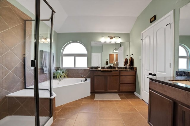 2405 Billy Pat Rd, Leander, TX 78641 - full bath with plenty of natural light, two vanities, a stall shower, vaulted ceiling, and a bath