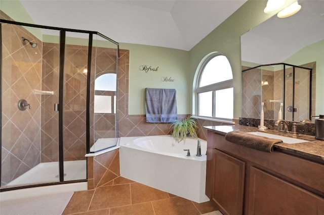 2405 Billy Pat Rd, Leander, TX 78641 - bathroom featuring a bath, vanity, a shower stall, tile patterned flooring, and tile walls
