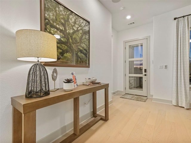 entryway featuring light wood-style floors, recessed lighting, visible vents, and baseboards