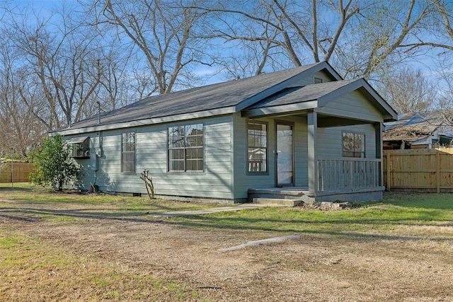 bungalow featuring a front yard, crawl space, and fence