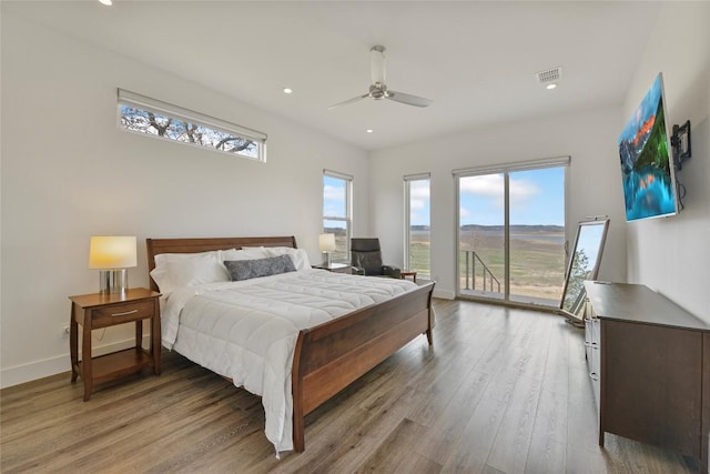 bedroom with baseboards, a ceiling fan, wood finished floors, access to exterior, and recessed lighting