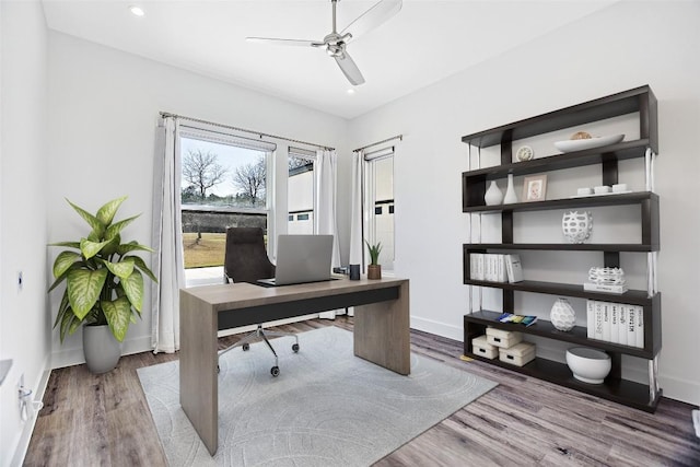 office area featuring ceiling fan, baseboards, and wood finished floors