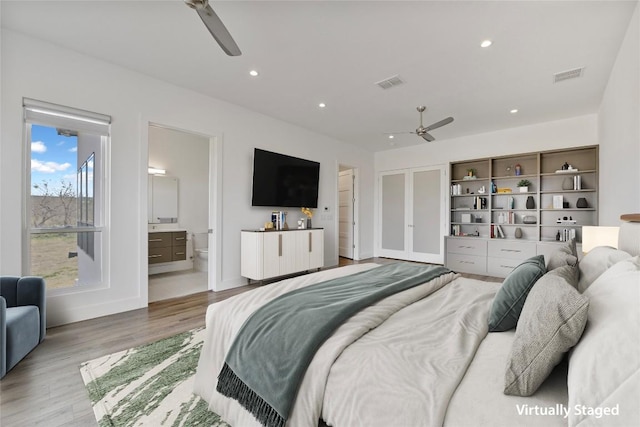 bedroom with visible vents, wood finished floors, and recessed lighting