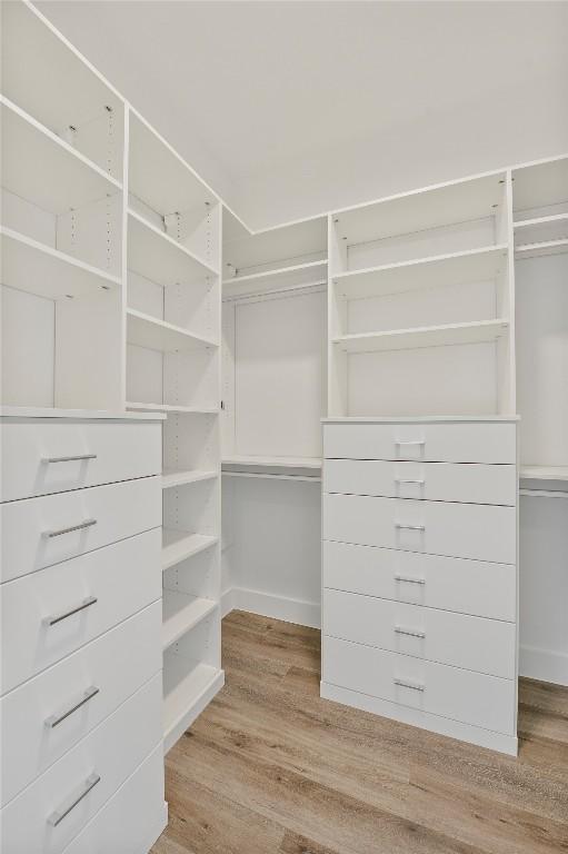 walk in closet with light wood-type flooring