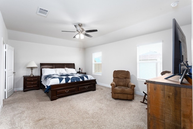 bedroom featuring visible vents, ceiling fan, light carpet, and baseboards