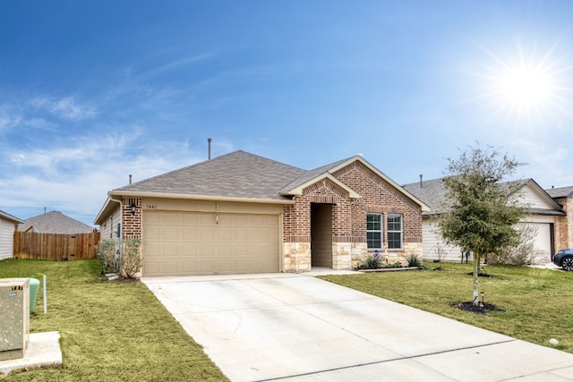 ranch-style home with a front yard, brick siding, and an attached garage