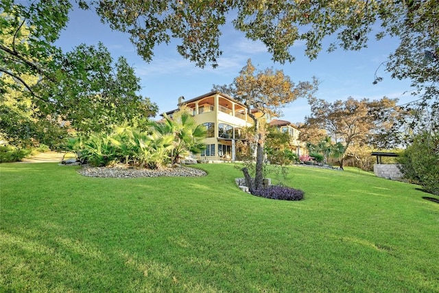 view of yard with a balcony