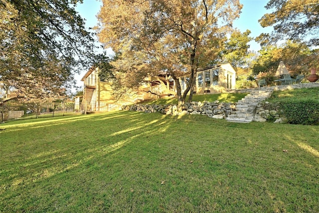 view of yard featuring stairs and fence