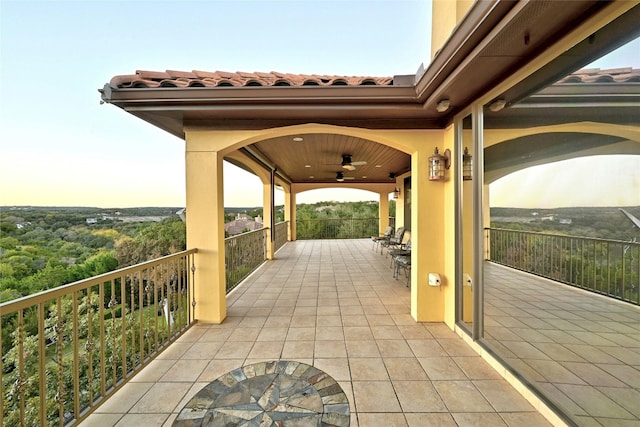 view of patio / terrace with ceiling fan and a balcony