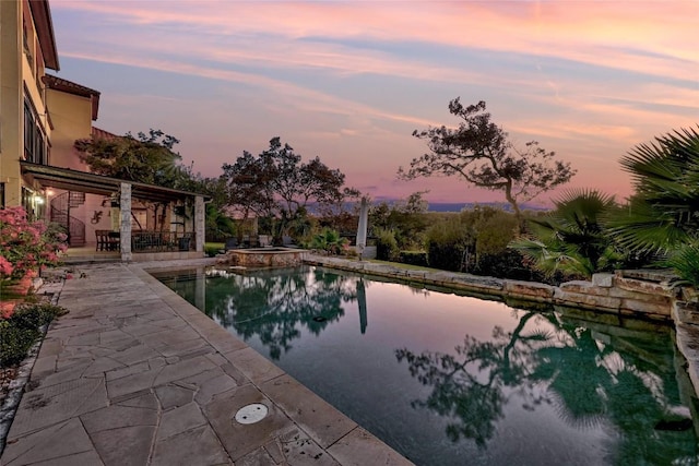 view of swimming pool with a patio area and a pool with connected hot tub