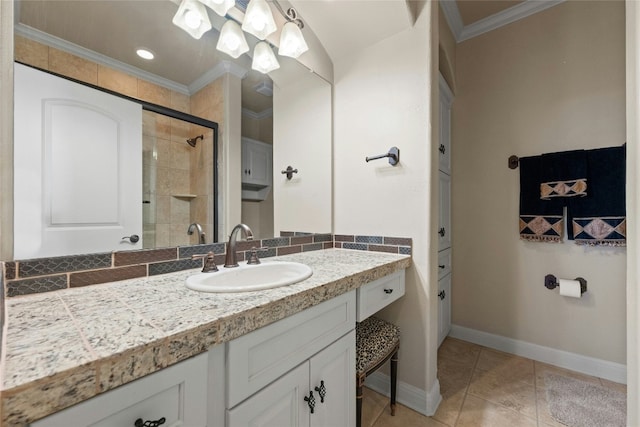 bathroom with crown molding, a shower stall, vanity, tile patterned flooring, and baseboards