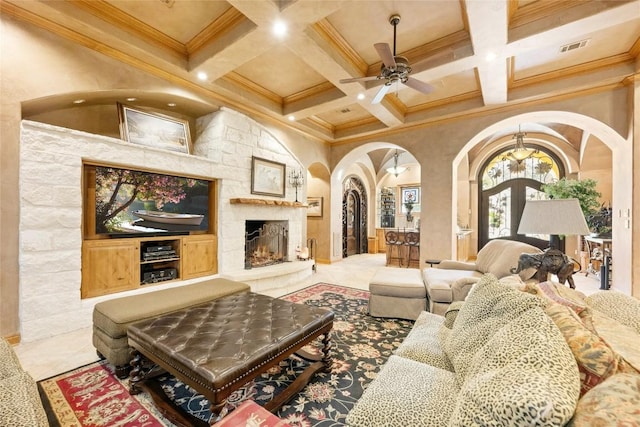 tiled living room featuring arched walkways, beamed ceiling, coffered ceiling, and visible vents