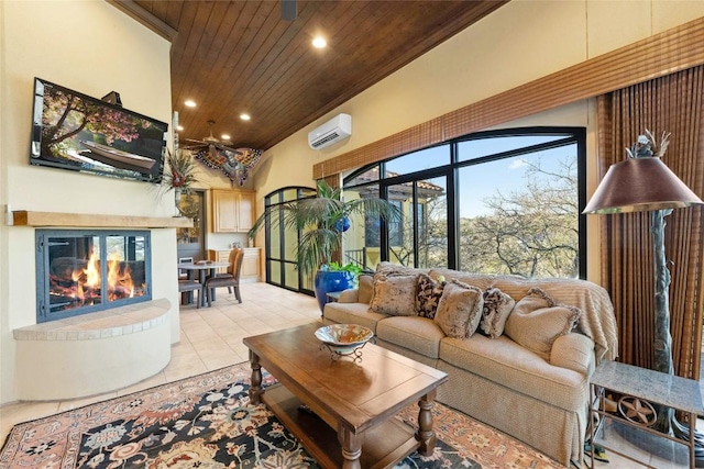 living area with a wall unit AC, light tile patterned floors, recessed lighting, a tiled fireplace, and wooden ceiling