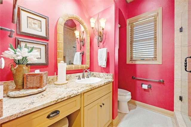 full bath featuring a stall shower, baseboards, toilet, tile patterned floors, and vanity