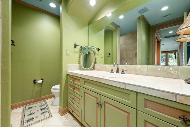 bathroom featuring toilet, vanity, tile patterned flooring, and visible vents