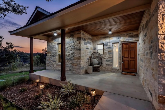 property entrance featuring stone siding