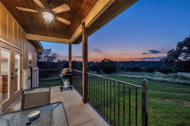 balcony featuring a ceiling fan and french doors