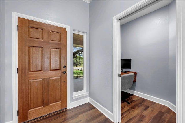 foyer featuring baseboards and dark wood finished floors