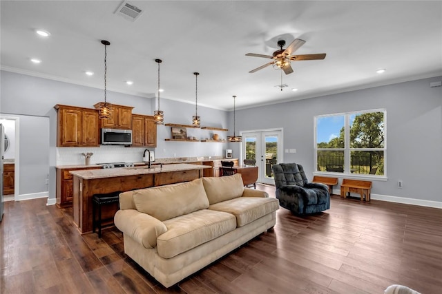 living area with visible vents, baseboards, french doors, dark wood-style floors, and crown molding