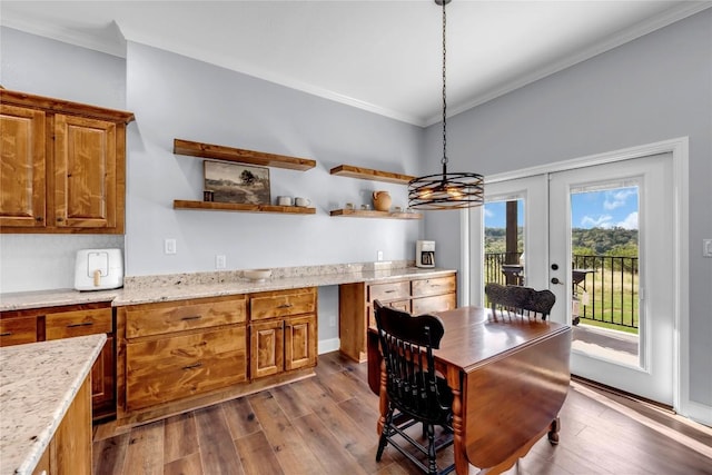 dining area featuring dark wood-style floors, french doors, and ornamental molding