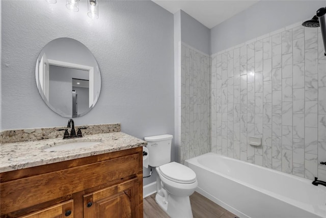 bathroom featuring wood finished floors, bathtub / shower combination, vanity, and toilet