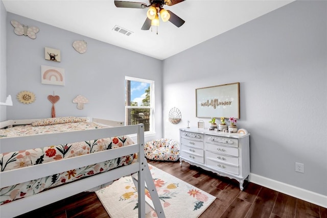 bedroom with visible vents, dark wood finished floors, baseboards, and ceiling fan