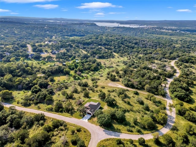 drone / aerial view featuring a forest view