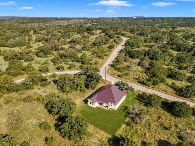 birds eye view of property with a forest view