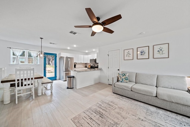 living area with ceiling fan, light wood-style flooring, visible vents, and recessed lighting