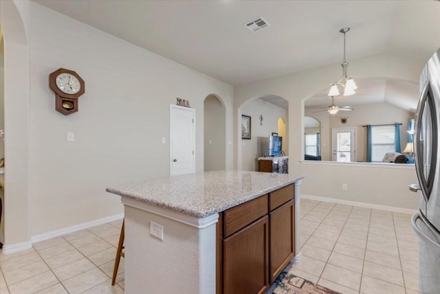 221 Joseph Dr, Buda, TX 78610 - kitchen featuring arched walkways, visible vents, hanging light fixtures, and light tile patterned floors