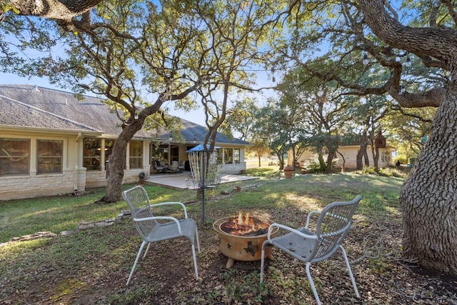 view of yard featuring an outdoor fire pit and a patio area