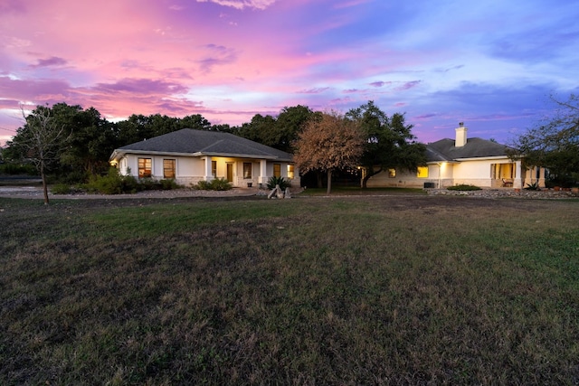 single story home with a yard