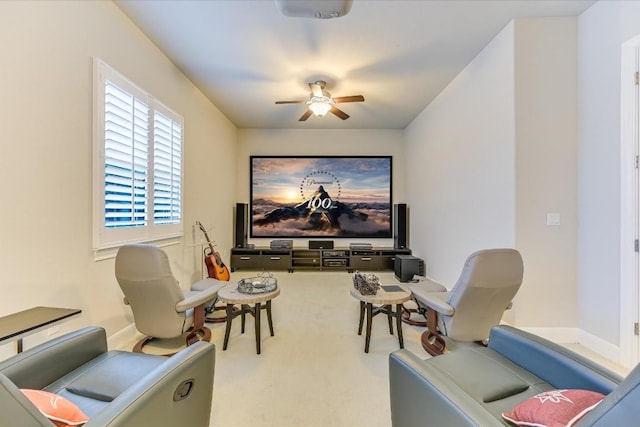 sitting room with ceiling fan, carpet floors, and baseboards