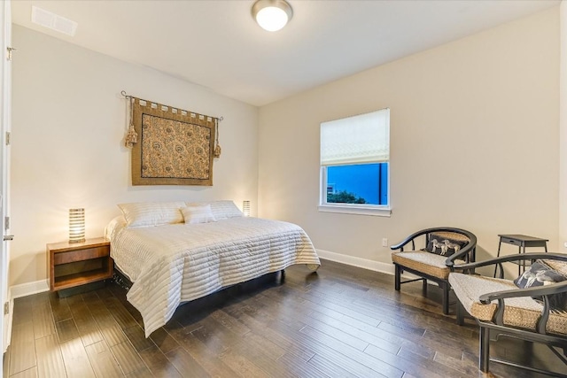 bedroom featuring dark wood-type flooring, visible vents, and baseboards