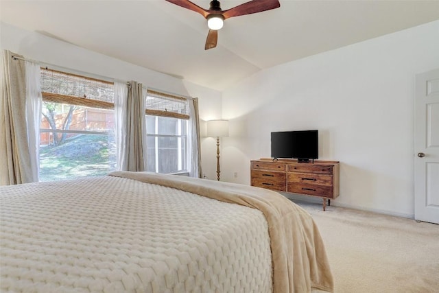 bedroom featuring carpet floors, lofted ceiling, baseboards, and a ceiling fan