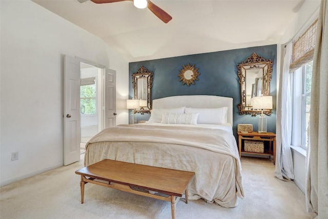 carpeted bedroom with lofted ceiling, baseboards, and a ceiling fan