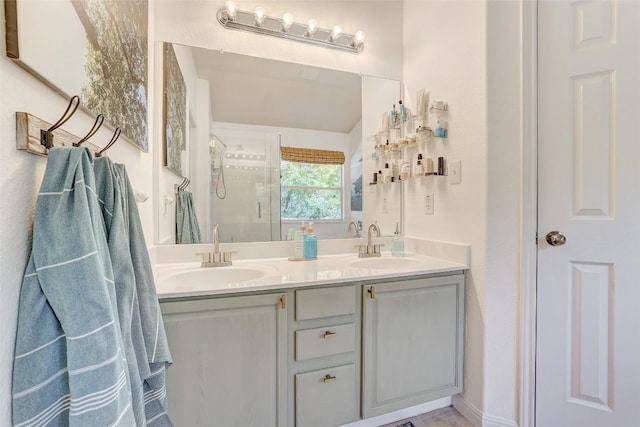 full bathroom featuring double vanity, a stall shower, and a sink