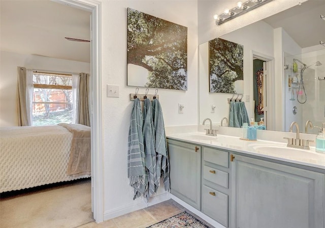 ensuite bathroom featuring tile patterned floors, double vanity, a sink, and ensuite bathroom